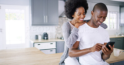 Buy stock photo Black couple, phone and hug in kitchen with social media, subscription and funny video on internet. Happy man, woman or mobile in home for relax, good news and love at counter with streaming platform
