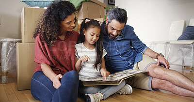 Buy stock photo Memory, parents and girl with photo album in new home for moving in, nostalgia and pointing to old house. Happy, people or kid on floor with pictures for unpacking, relocation together or real estate