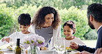 Dinner, parents or children with food outdoor for eating, festive celebration or social gathering. Thanksgiving, people and healthy meal together on patio with care, holiday event and bonding by home