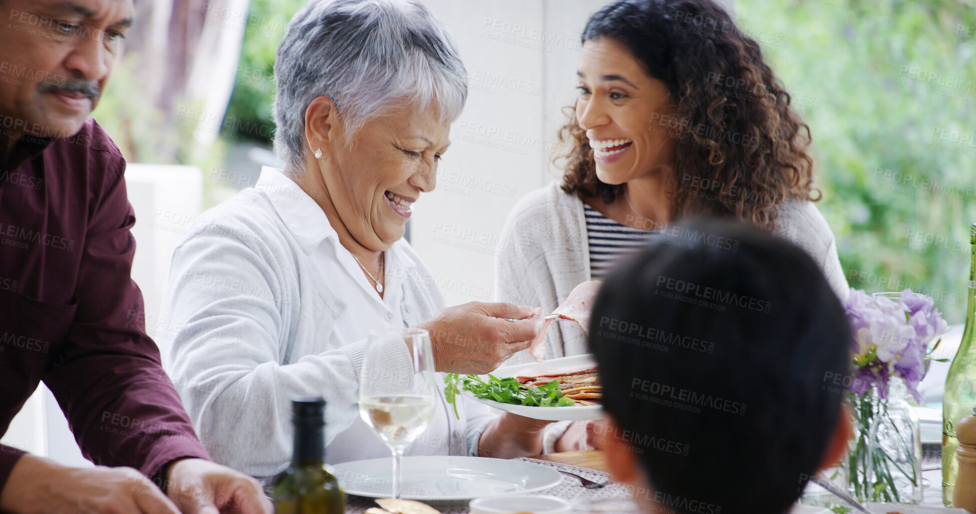 Buy stock photo Thanksgiving, dinner and family with eating by home for bonding, festive celebration or social gathering. Happy people, food or conversation together on patio with love, holiday lunch or relationship