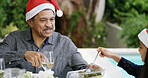 Christmas, lunch and family helping with food for festive celebration, bonding or support outdoor. Brunch, senior man or happy girl on patio for holiday dinner, social gathering or fun with santa hat