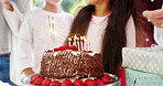 Birthday cake, celebration and candles for child and family to have fun and enjoy surprise at home. Kids, dessert and people together at party event with food, gifts and closeup of milestone in house