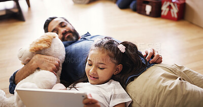 Buy stock photo Child, tablet and relax in home with father, streaming media and online game for entertainment. Man, daughter and tech on living room floor for cartoon, relationship development or bonding on weekend