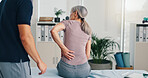 Back pain, physiotherapy and consulting with old woman in clinic for healthcare, osteoarthritis or symptoms. Medical, physical therapy and helping with patient for chiropractor and rehabilitation