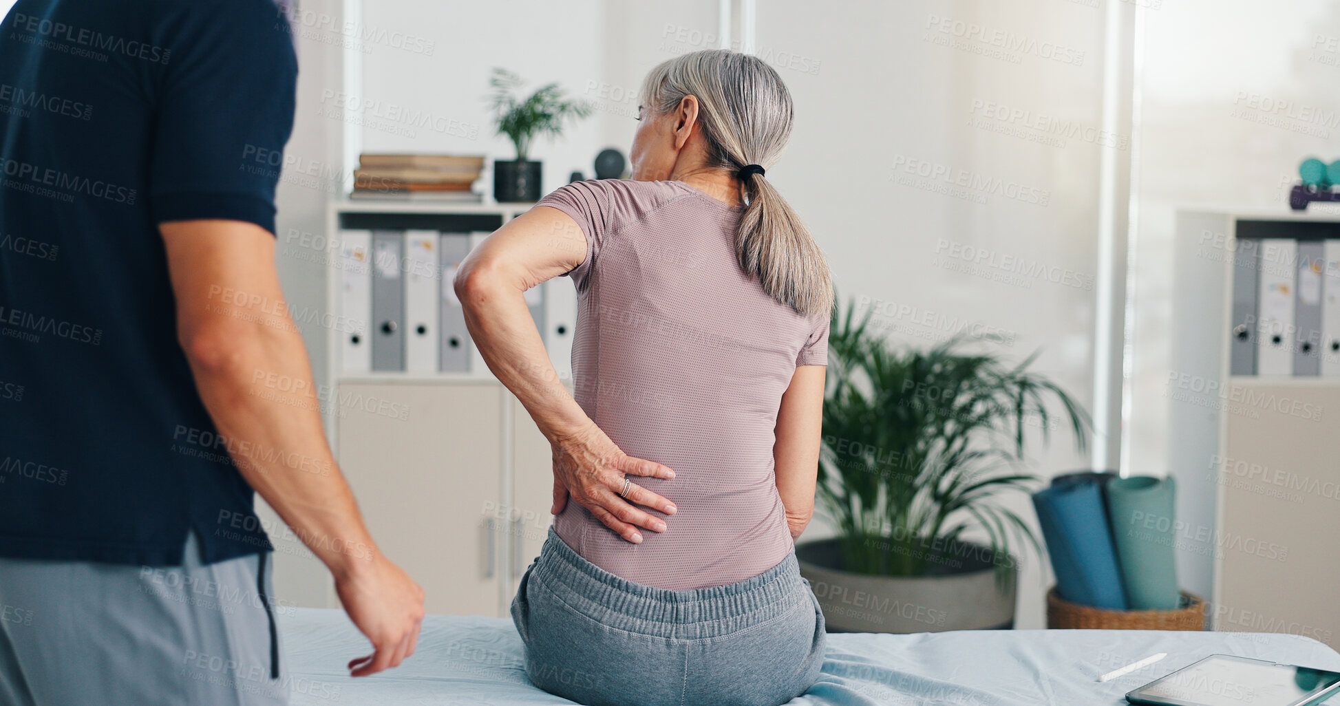 Buy stock photo Back pain, physiotherapy and consulting with old woman in clinic for healthcare, osteoarthritis or symptoms. Medical, physical therapy and helping with patient for chiropractor and rehabilitation