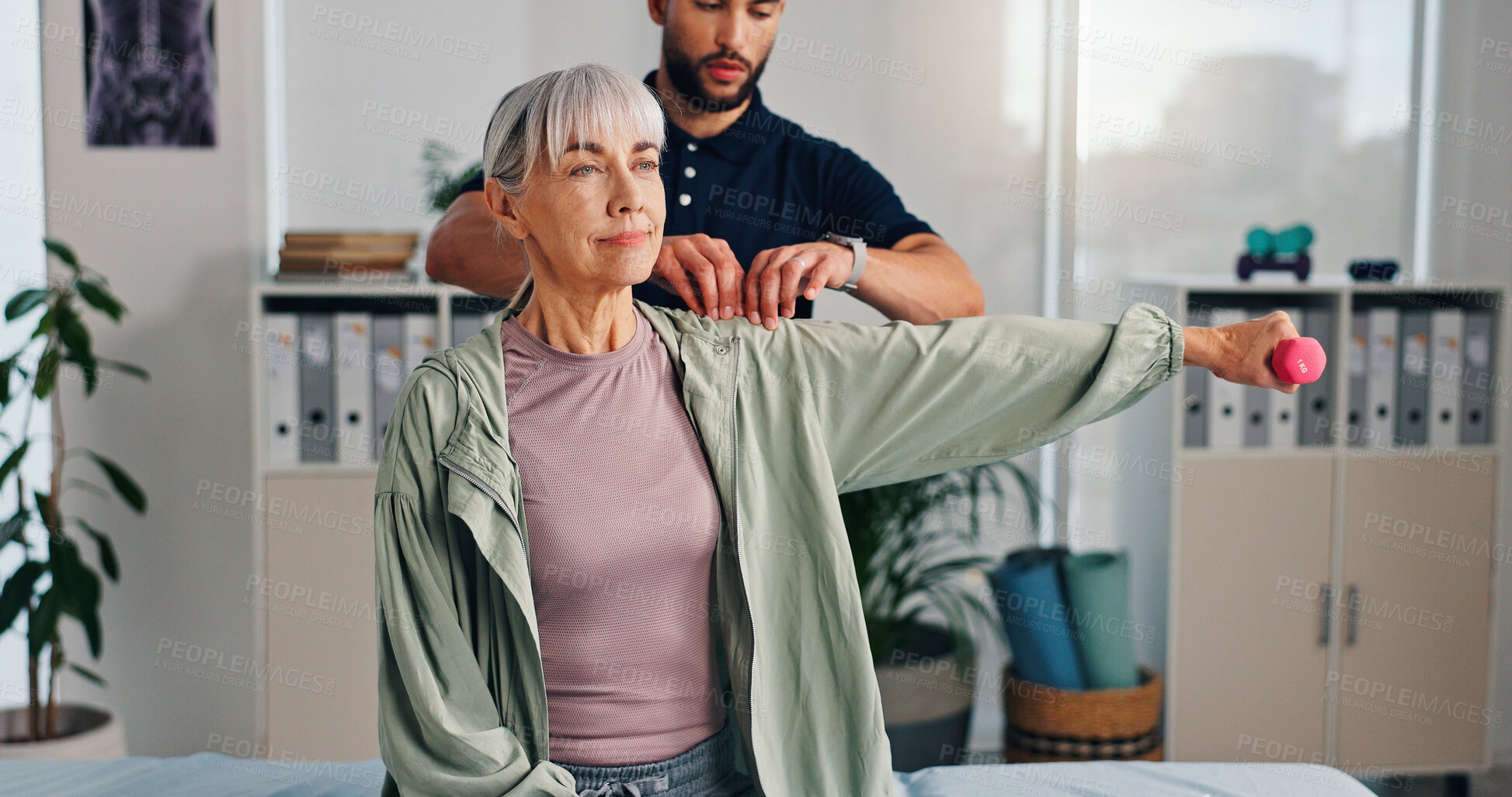 Buy stock photo Physiotherapy, shoulder or senior woman with dumbbells for rehabilitation, muscle exercise or body health. Mobility help, client or stretching with weights for fitness, physical recovery or balance