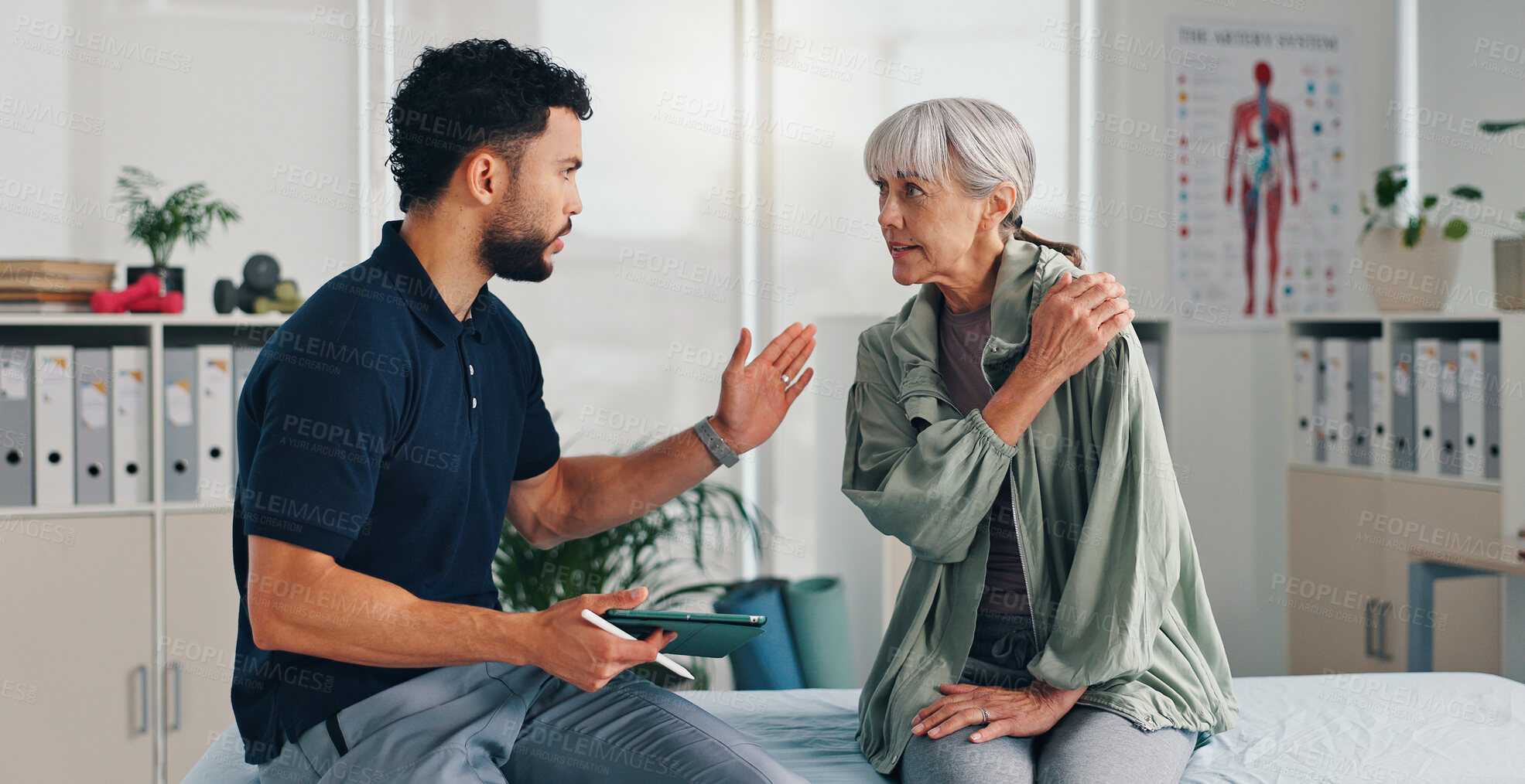 Buy stock photo Tablet, physical therapy and senior woman with shoulder pain at consultation for problem or arthritis. Person, patient or chiropractor and discussion for injury, rehabilitation and recovery of muscle