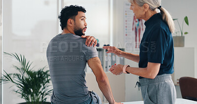 Buy stock photo Physical therapy, shoulder pain and patient man at consultation for problem or inflammation. Person, chiropractor and talking of injury, rehabilitation and recovery of joint or muscle damage