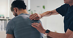 Physical therapy, back massage and hands on patient man at consultation for problem or inflammation. Person, chiropractor and touch for injury, rehabilitation and recovery of spinal or muscle damage