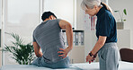 Back pain, physical therapy and patient at consultation for problem, inflammation or muscle strain. People, chiropractor and treatment for injury, rehabilitation and recovery of spinal ligaments
