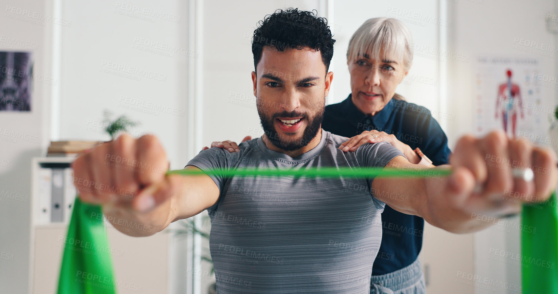 Buy stock photo Physiotherapist, woman or man with resistance band for shoulder rehabilitation, muscle exercise or health. Mobility, help or client stretching with elastic for fitness, physical recovery or balance