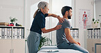 Chiropractor, back massage and physiotherapy on patient at consultation for spine problem or inflammation. Person, physical therapy on injury for rehabilitation or recovery of muscle damage in clinic