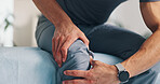 Pain, knee and person with hands on injury for problem, inflammation or arthritis disease. Patient, closeup and health issue of cramp, hurt joint or risk of muscle damage and osteoporosis in body
