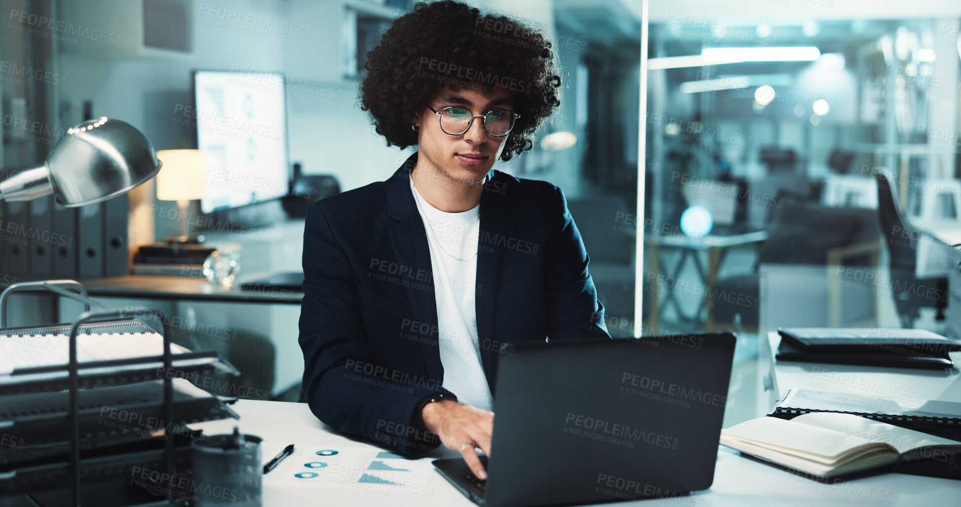 Buy stock photo Night, man and laptop in office for finance, business management and budget review at paper. Accountant, tech and profit report in agency for audit deadline, tax compliance and charts for information