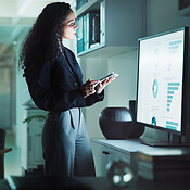 Data analysis, tablet and monitor with business woman in office for ...