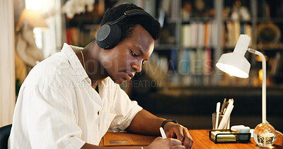 Buy stock photo Headphones, college and writing with black man in home office for listening, course and scholarship. Streaming, university student and education podcast with person and study for report and project