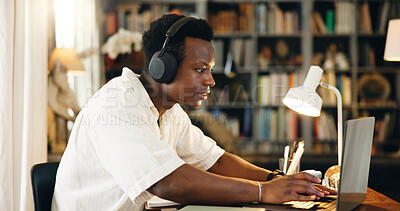 Buy stock photo Black man, studying and typing on laptop, home and reading with e learning, development and research in library. Person, computer and student with education, music and online course at apartment