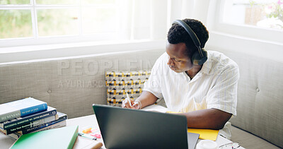 Buy stock photo Black man, education and writing with headphones, home and listen for e learning, development and progress. Student, notes and books with streaming, class and scholarship for college project in house