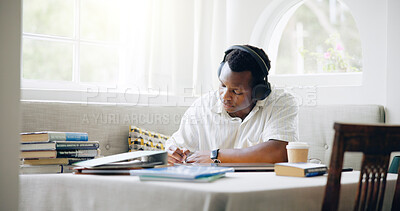 Buy stock photo African man, student and headphones in home with books, writing or learning with listening to music with scholarship. Person, notes and streaming with studying, education or planning for college exam