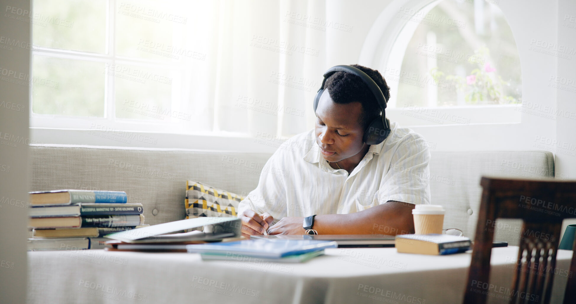 Buy stock photo African man, student and headphones in home with books, writing or learning with listening to music with scholarship. Person, notes and streaming with studying, education or planning for college exam