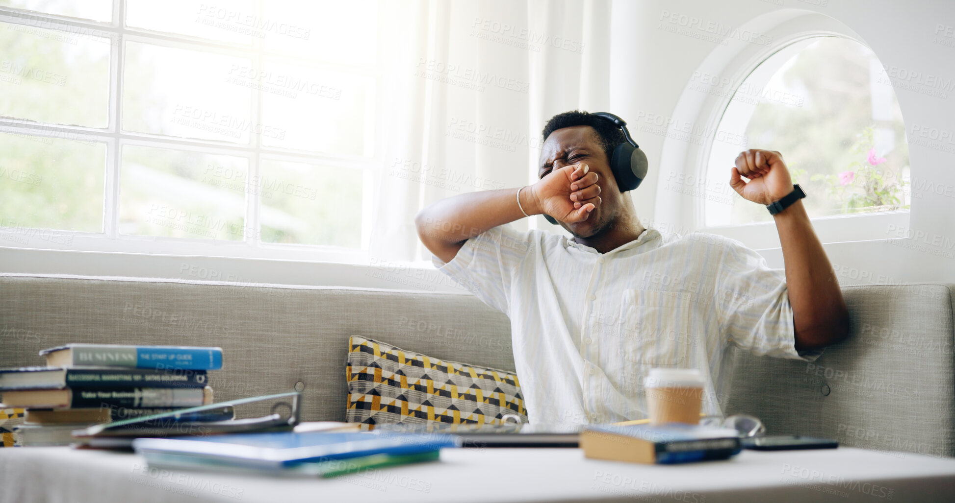 Buy stock photo Black man, student and tired with yawn in home with headphones, books or learning with music for scholarship. Person, exhausted and streaming with studying, education or burnout with fatigue in house