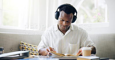 Buy stock photo Black man, books and headphones with reading in home with studying, assessment or listening to music with scholarship. Person, student and streaming with notes, education or learning for college exam