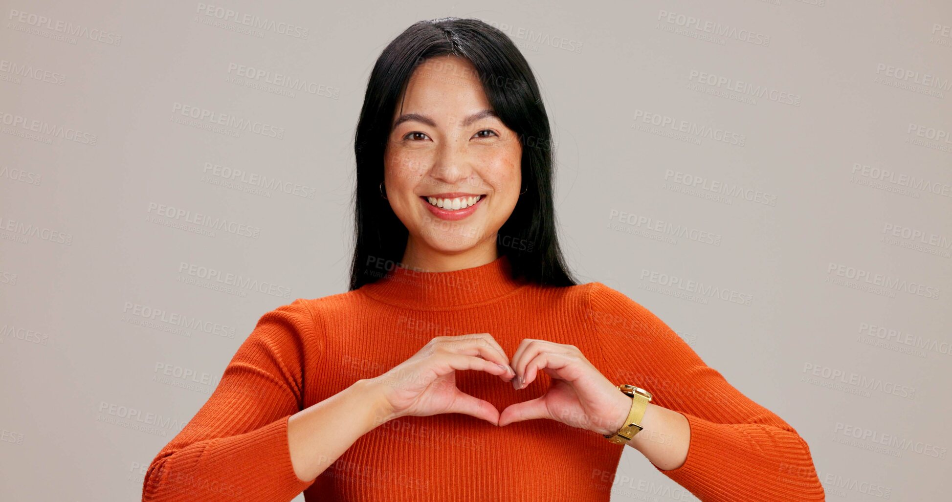 Buy stock photo Asian girl, heart hands and happy in studio portrait, excited and icon with kindness, care and love by background. Woman, person and model with symbol, emoji and sign for valentines day in Taiwan