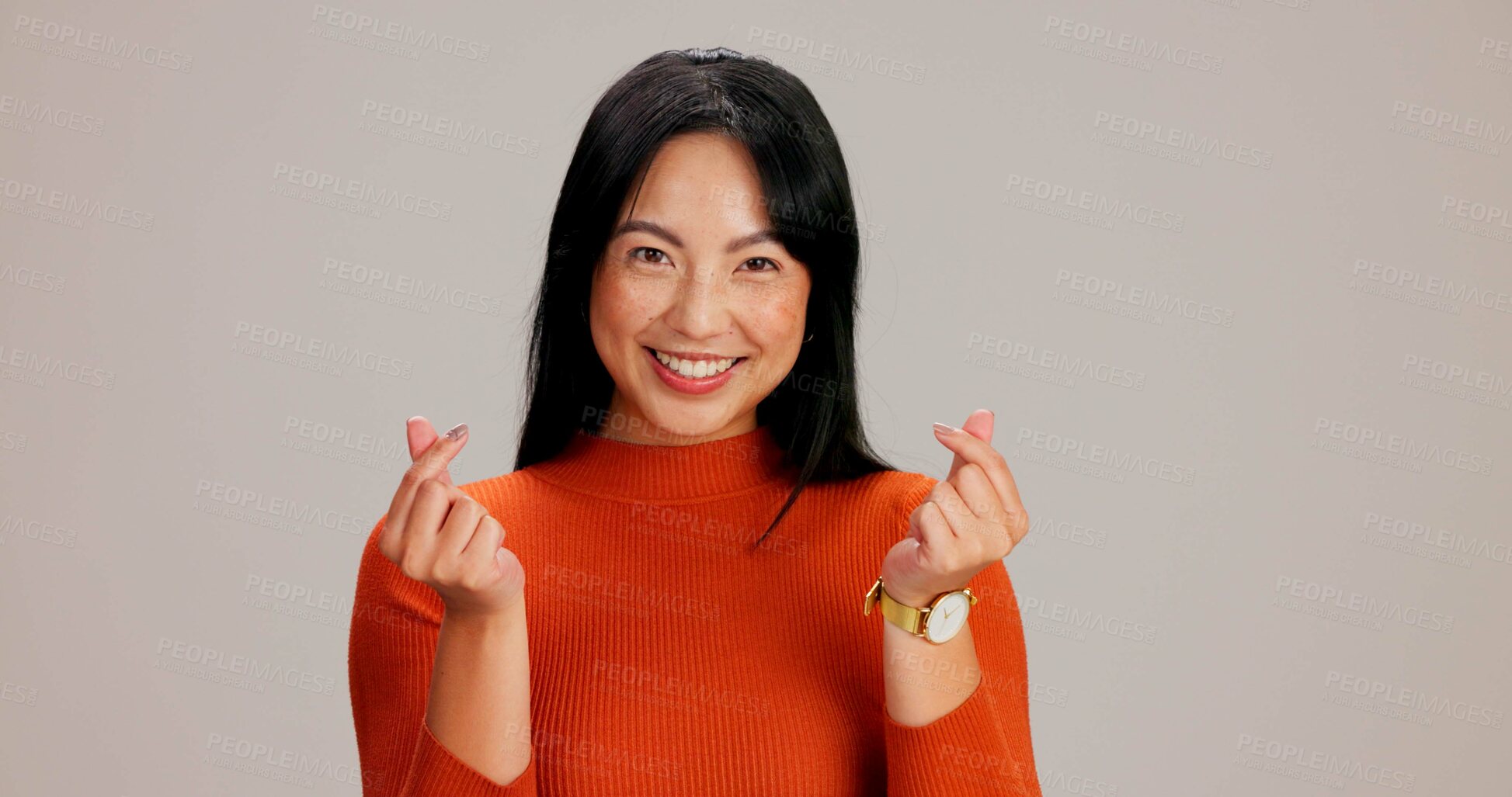 Buy stock photo Asian girl, finger heart and happy in studio portrait, excited and icon with kindness, care and love by background. Woman, person and model with symbol, emoji and sign for valentines day in Taiwan