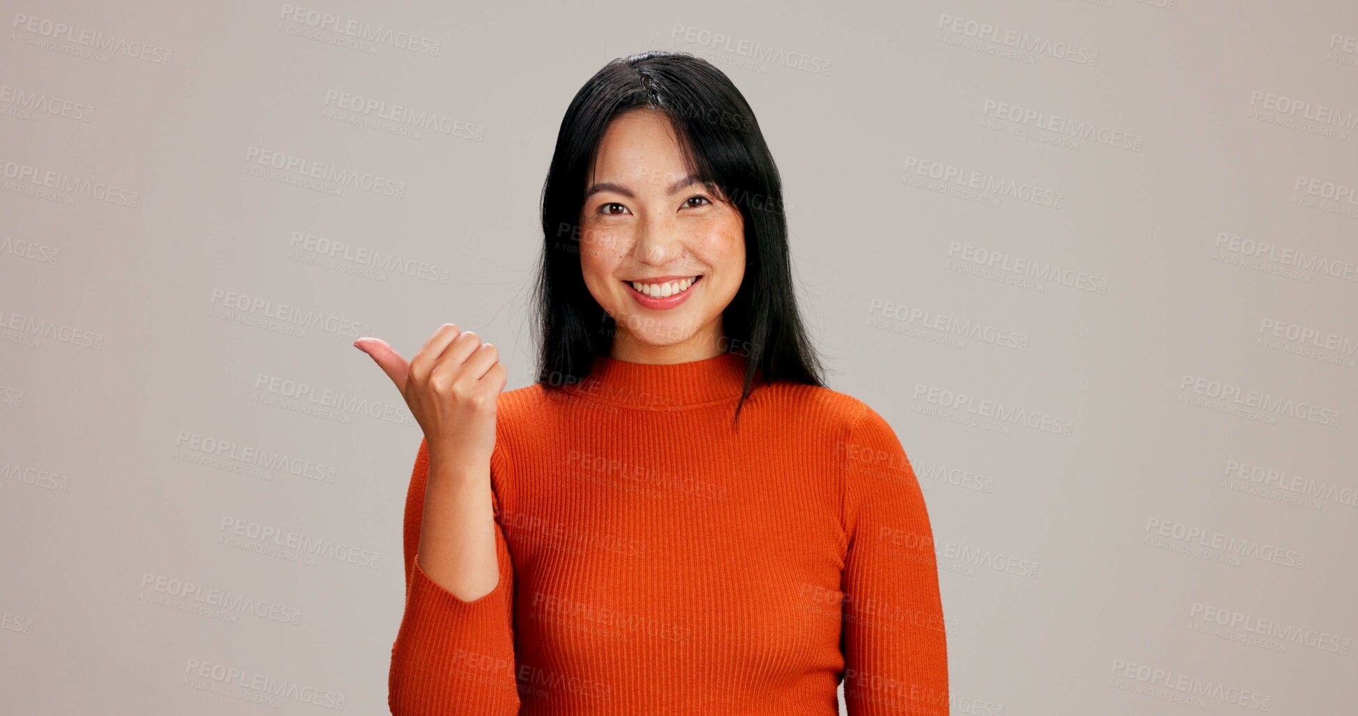 Buy stock photo Woman, portrait and pointing to advertising presentation on studio background for promotion launch or sale offer. Happy, person and mockup space for about us info, deal announcement and coming soon