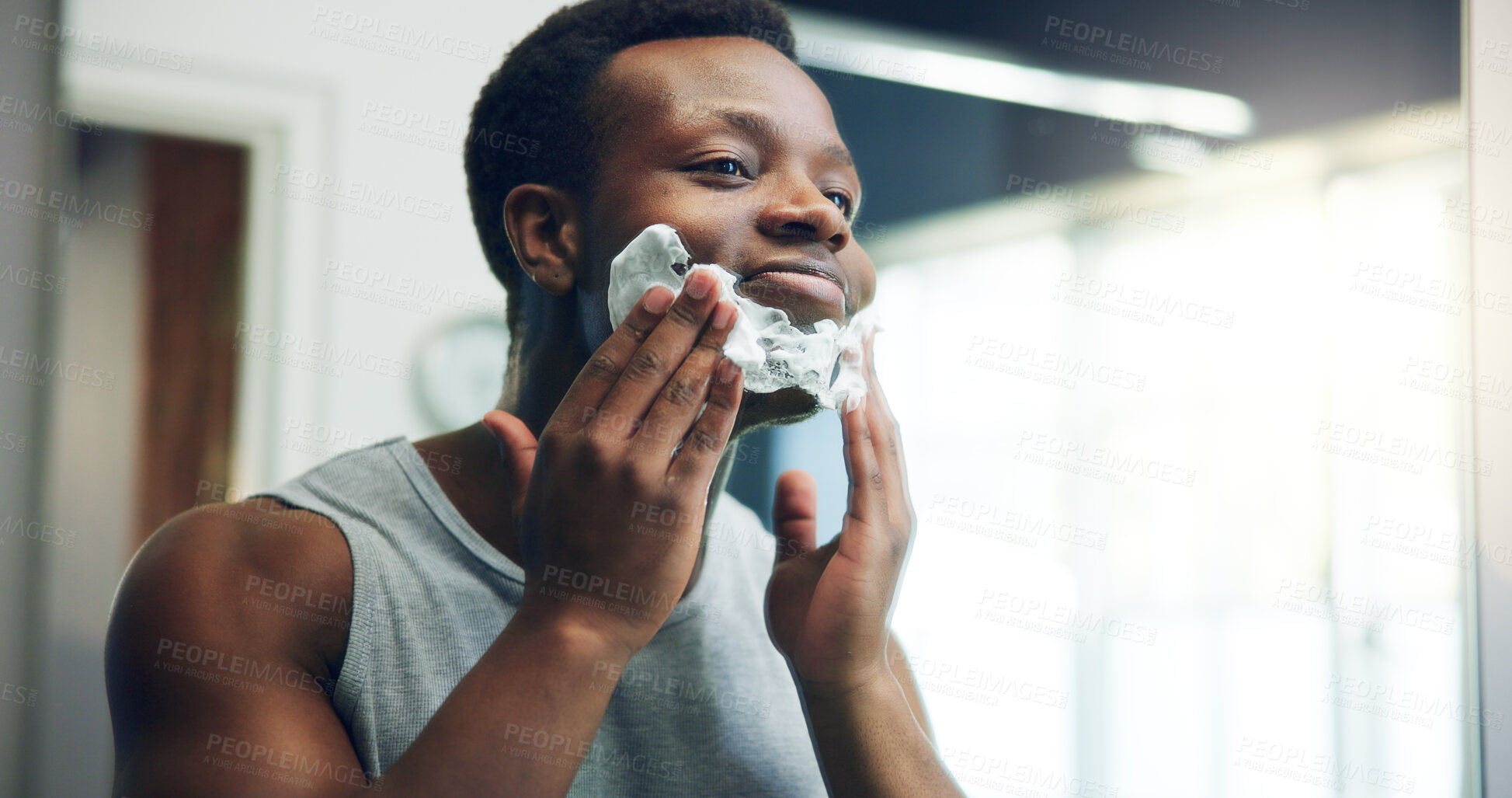 Buy stock photo Black man, face and shave with cream for grooming, epilation or hair removal in mirror at home. African, male person or facial with aftershave creme for clean beard or skincare routine in bathroom