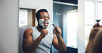 Man, razor and shaving with singing in mirror with smile, hygiene and skincare routine in home. African person, point and karaoke in bathroom with beard, foam and cream with transformation in morning
