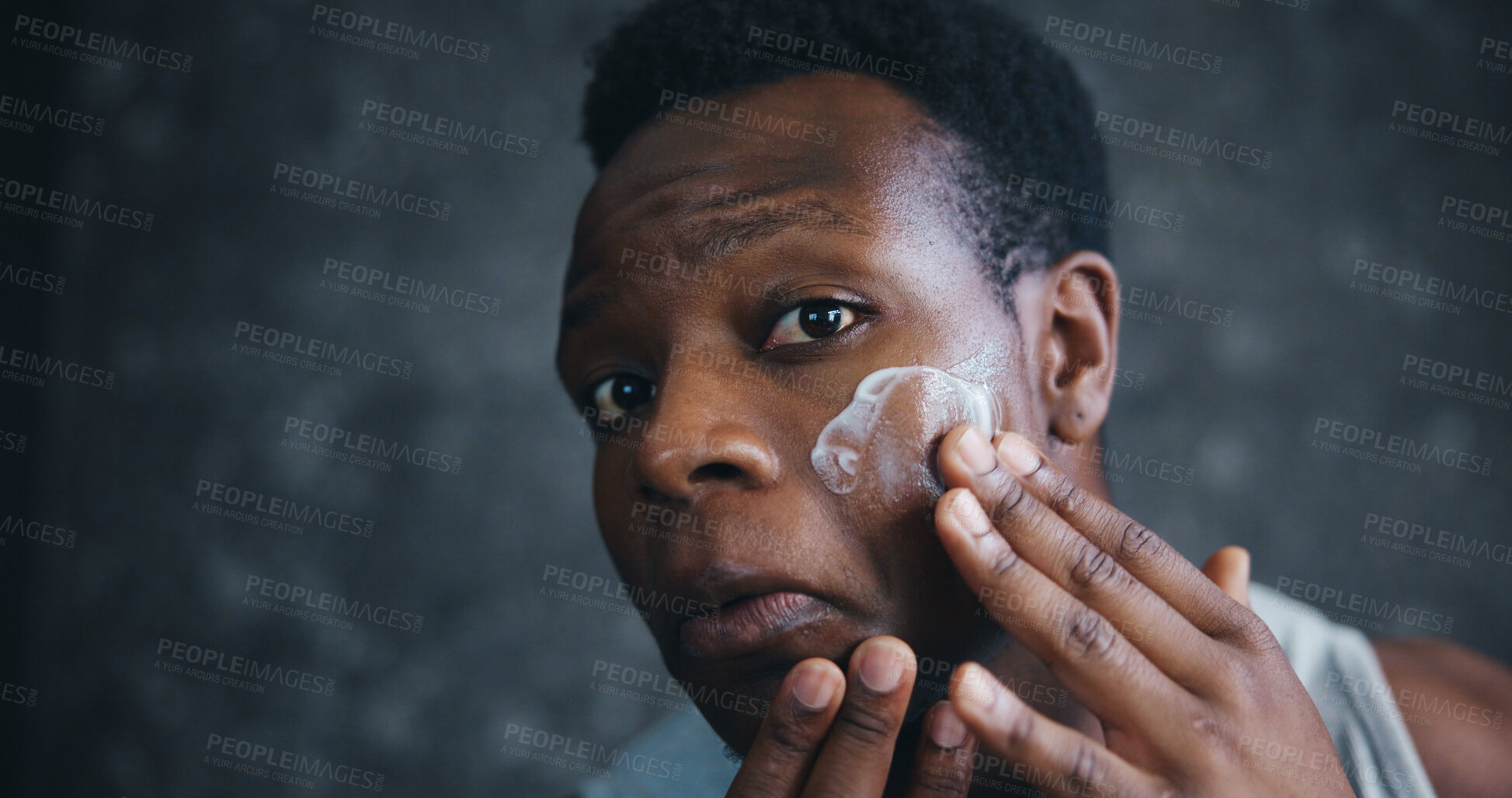 Buy stock photo Black man, skincare and cream in home with check for results, glow or change with serum in morning. Person, creme and product for cosmetics, wellness or facial transformation in bathroom at apartment