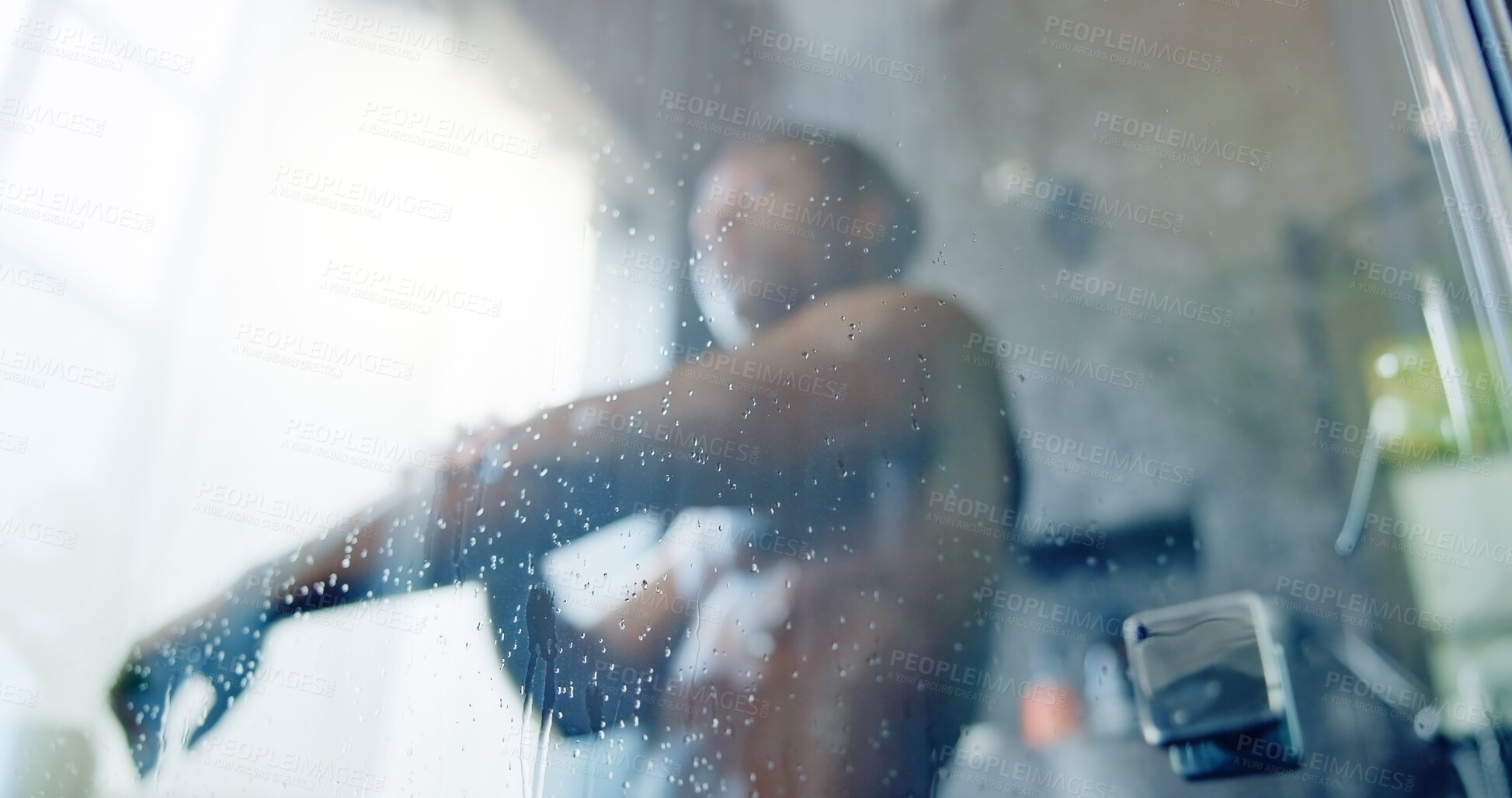 Buy stock photo Glass, shower and person in bathroom, home or washing body for hygiene with low angle in morning. Drops, water and cleaning skin with routine, soap and grooming process for bacteria at apartment
