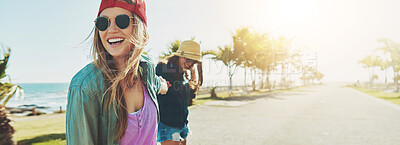 Buy stock photo Friends, beach road and happy on summer holiday while holding hands on adventure together. Women, fun travel and excited by ocean with skater style, outdoor banner and joy on vacation in miami space