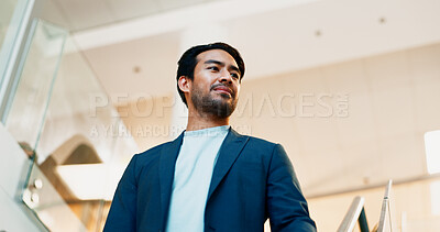 Buy stock photo Businessman, commute or walking with suit in office building for career ambition or new job opportunity. Asian man, employee or corporate traveler with vision below for company growth or immigration