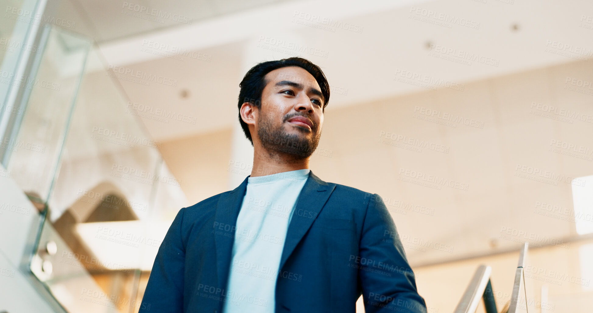 Buy stock photo Businessman, commute or walking with suit in office building for career ambition or new job opportunity. Asian man, employee or corporate traveler with vision below for company growth or immigration