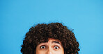 Man, portrait and eyes with shock or surprise on studio for news, announcement or alert on a blue background. Male person, model or OMG expression with afro or hairstyle for gossip on mockup space