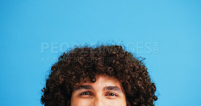 Buy stock photo Man, head and portrait with space in studio for curly hair, style or volume isolated on a blue background. Male person, hairstyle or young model with mockup, eyes or awareness for afro, mind or sight