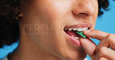 Buy stock photo Chewing gum, dental and closeup of person in studio for fresh breath, oral hygiene or candy. Cleaning, mint sweets or bubblegum with snack and mouth on blue background for teeth care and eating