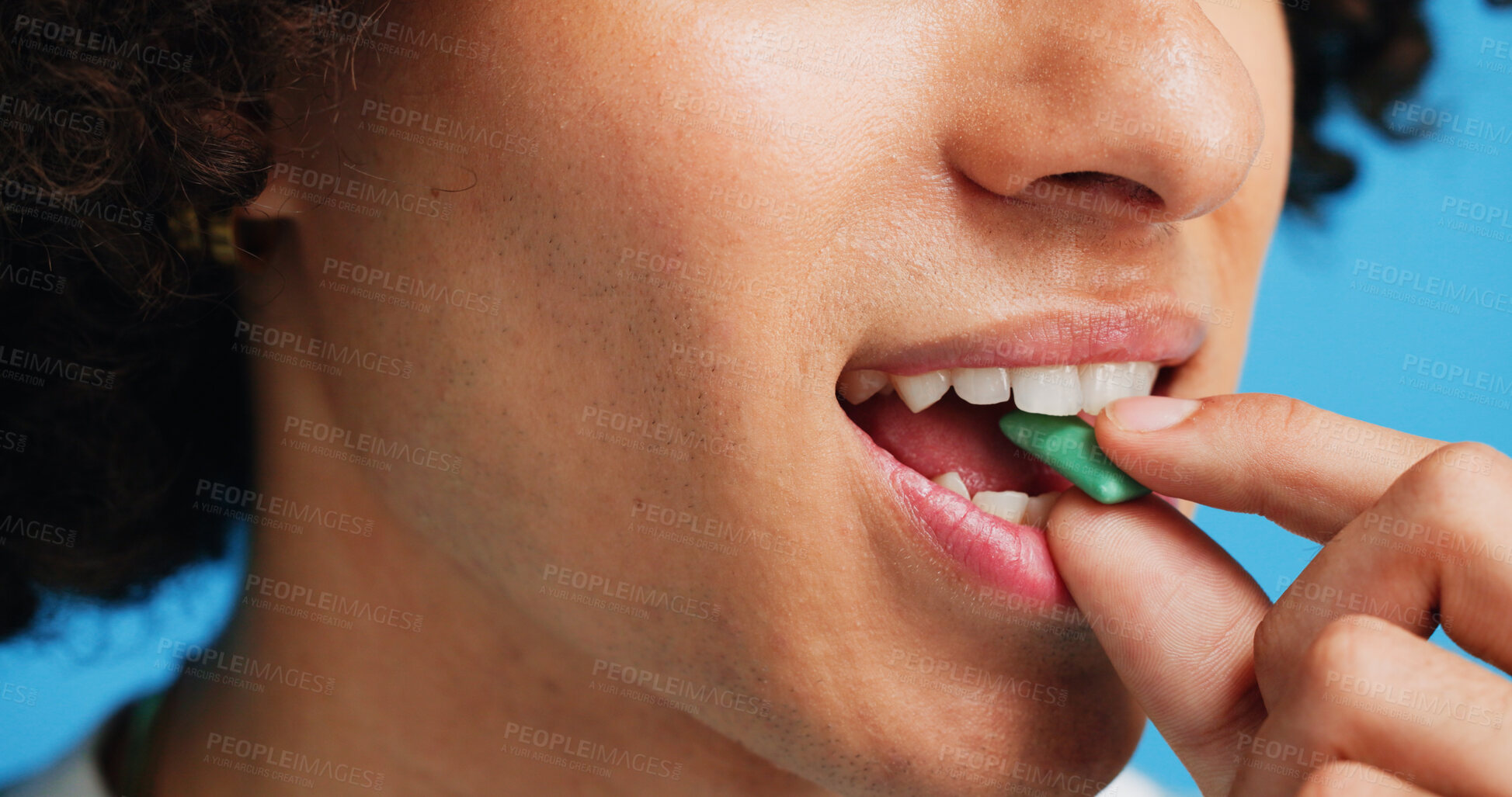 Buy stock photo Chewing gum, dental and closeup of person in studio for fresh breath, oral hygiene or candy. Cleaning, mint sweets or bubblegum with snack and mouth on blue background for teeth care and eating