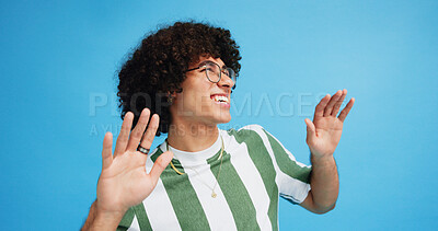 Buy stock photo Dance, smile and fashion with man in studio for celebration, freedom and gen z with cool style. Happiness, energy and afro hair with male person on blue background for hip hop music, audio and fun