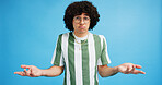Shrug, confused and man in studio portrait with puzzled expression, emoji or gesture. Geek, unsure and afro hair guy with glasses and doubt of decision, question or hands up on blue background mockup
