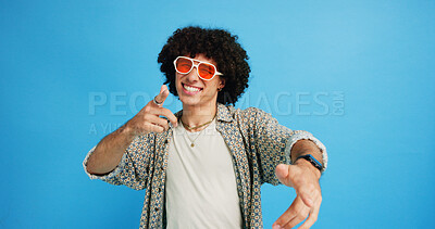 Buy stock photo Happy man, portrait and sunglasses with fashion or funky style on a blue studio background. Male person, hipster or young model with stylish shades or cool attitude for summer party or New Year mood