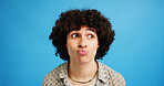 Man, face and pout with afro for kiss, flirty expression or dream in fashion on a blue studio background. Male person, gen z or model looking with curly hair, funny attitude or plump lips on space