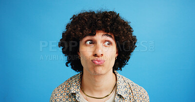 Buy stock photo Man, face and pout with afro for kiss, flirty expression or dream in fashion on a blue studio background. Male person, gen z or awkward model with curly hair, funny attitude or emoji lips on space