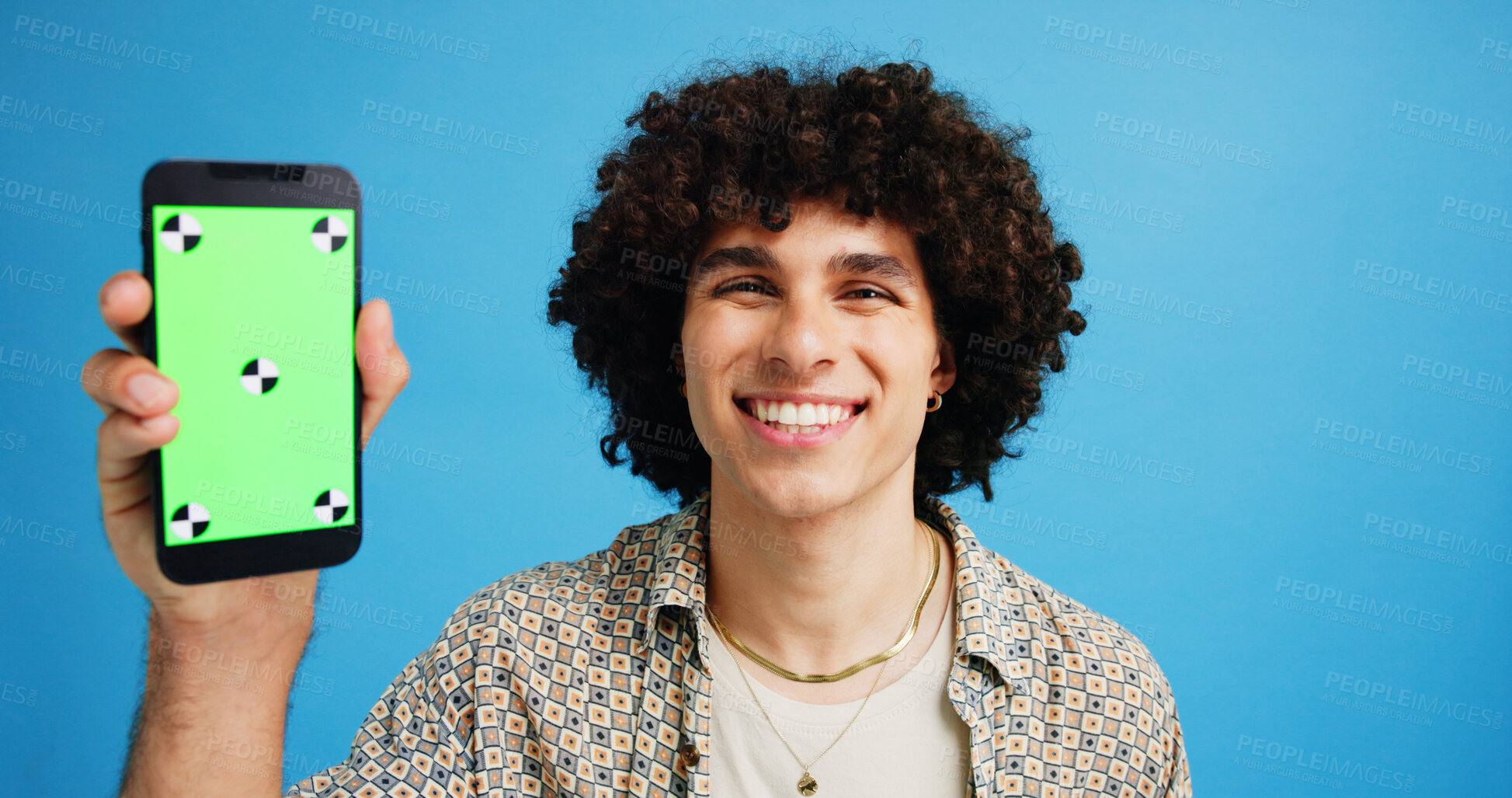 Buy stock photo Happy man, portrait and phone with green screen in studio for online marketing or advertising on a blue background. Male person, user or model with smile or mobile smartphone display for software app