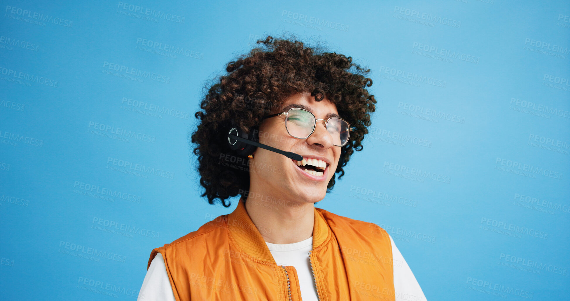 Buy stock photo Studio, man and laughing with headset for call center, communication and customer service for sales. Space, male person and agent with mic for client support, happy and business by blue background