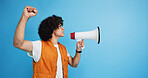 Man, profile and activist with bullhorn in studio for protest, strike or announcement on a blue background. Male person, rebel or march with loudspeaker for awareness, alert or message on space