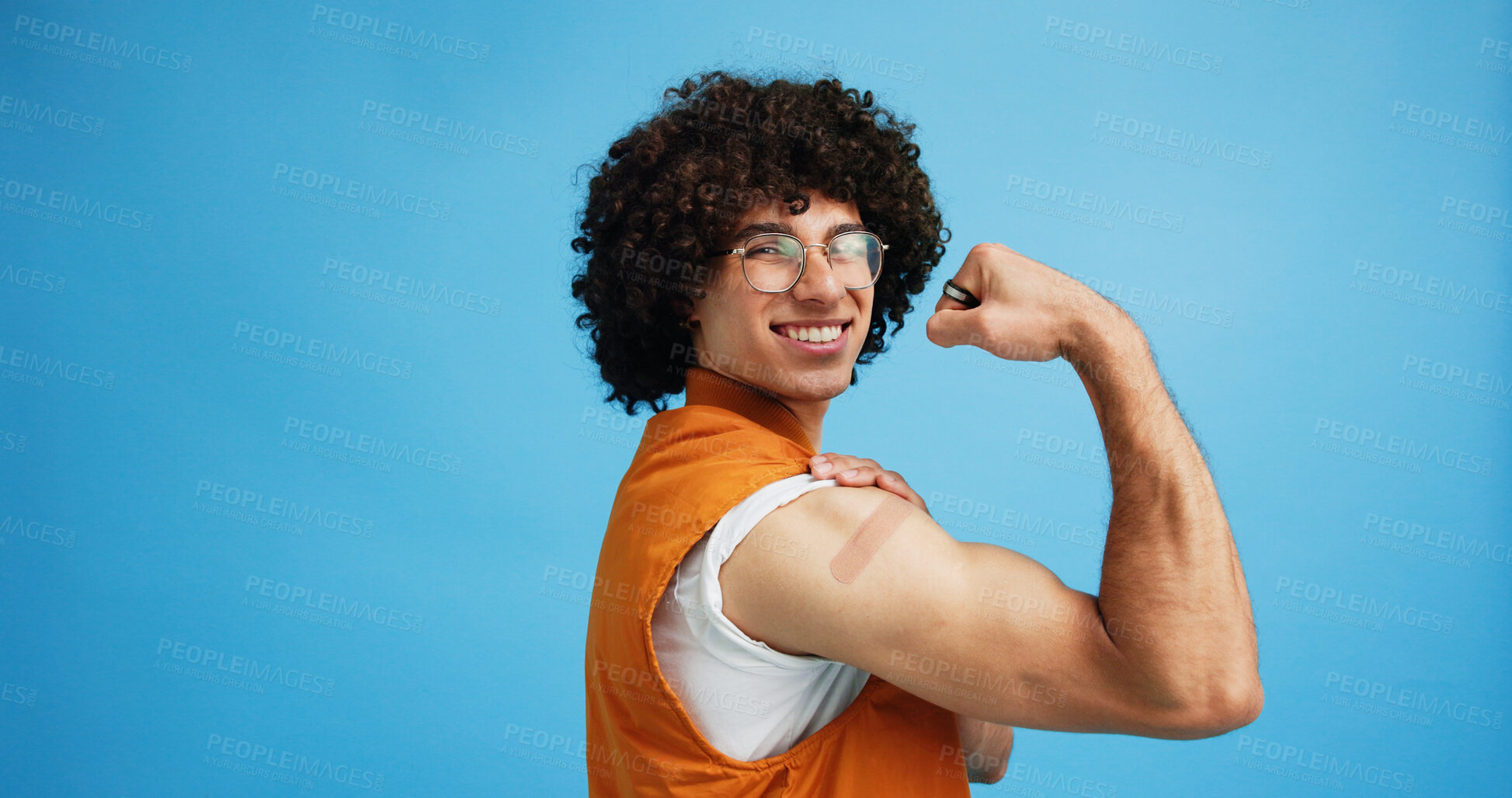 Buy stock photo Studio, man and flex with bandage after vaccine, medical treatment and prevention of flu disease. Mockup space, male person or portrait with plaster for healthcare, virus awareness or blue background