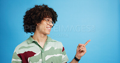 Buy stock photo Pointing, smile and excited man with opinion, announcement and advertising in studio. Blue background, promotion and happy person with hand gesture, confidence and information in mockup space